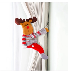 Close-up of reindeer plush curtain tieback in brown and red on white fabric