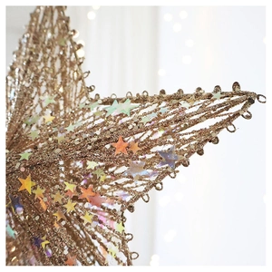 Detailed view of champagne gold Christmas tree star topper with sequins and glitter