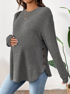 Detail shot of grey maternity long sleeve top with ribbed knit fabric and side button accents