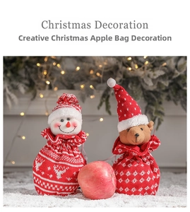 Close-up of knitted Christmas gift bags featuring plush snowman and bear characters