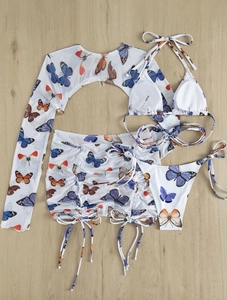 Flat lay of butterfly print four-piece swimwear with mesh top and drawstring skirt