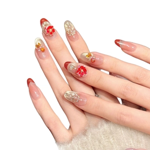 Red French tip press-on nails with 3D camellia flowers, pearls and golden glitter