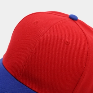 Detailed close-up of high-quality twill cotton stitching on a red and blue baseball cap