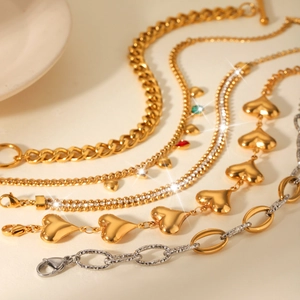 Elegant stainless steel heart charm bracelets with gold finish and rhinestone accents