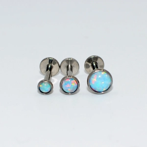 Three sizes of G23 titanium opal labret studs with iridescent blue and pink stones