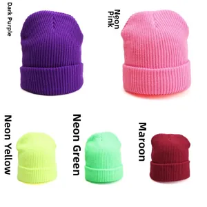 Detail view of colorful knit beanies in deep purple, neon pink, yellow, green and wine red