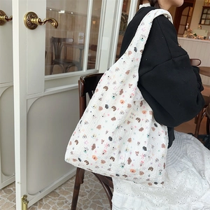 Detail showing the embossed bubble fabric and cute cartoon dog print of the tote bag
