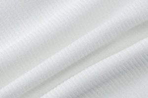Close-up of white ribbed knit fabric texture and high-quality weave for summer dress