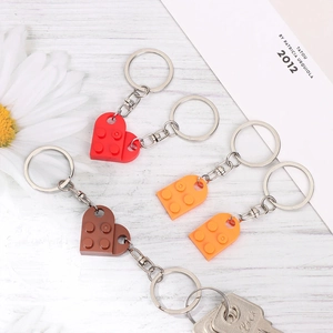 Macro shot of heart-shaped brick keychains with interlocking design on wood surface