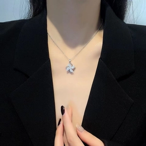 Elegant rotating windmill pendant necklace with sparkling zircons on silver chain