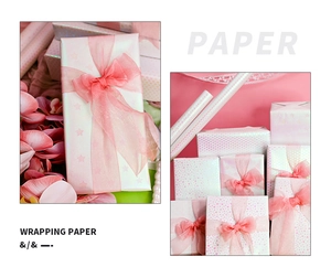 Detail of pink and white wrapping paper featuring star and heart patterns for gifts