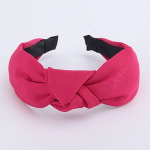 Detailed macro view of the rose red knotted fabric headband showing weave texture