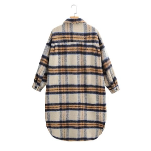 Detail of blue and yellow plaid wool coat with classic lapel and premium textured fabric