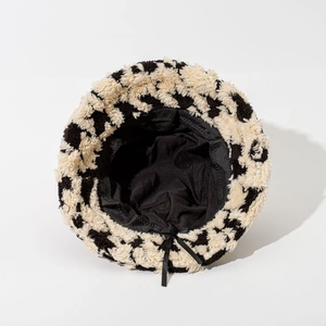 Thick plush houndstooth bucket hat in black and white fleece with inner adjustable strap