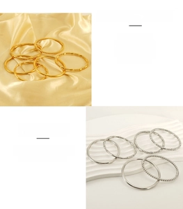 Dettaglio di vari bracciali rigidi in acciaio inossidabile oro e argento stile bambù