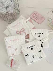 Quilted cotton pouches with bow embroidery and 'sweet' text in a four-piece set