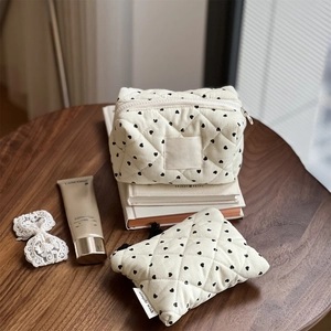 Close-up of heart print quilted cotton organizer set on a wooden table setup