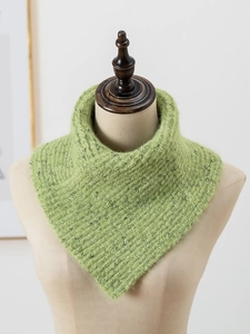 Detail showing the thick green knitted texture and flecked yarn of the winter neck warmer