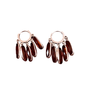 Vintage rose gold drop earrings with dark red oval glass tassels on a white background