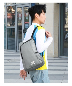 Waterproof nylon outdoor backpack in dark grey with mountain logo and branded print