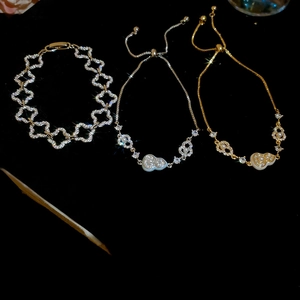 Close-up of 18k gold plated gourd charm bracelets with pearls and sparkling zircons
