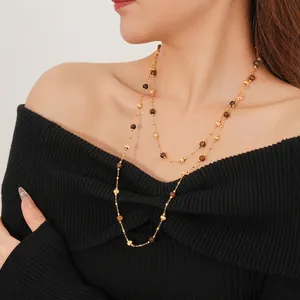 Double-layered gold plated necklace with tiger eye beads on black sweater