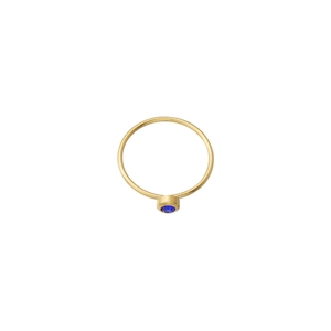 Detailed close-up of a minimalist gold ring with a round blue gemstone in bezel setting