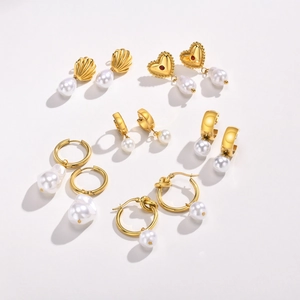Set of six vintage gold-plated pearl earrings in heart, knot, and shell designs