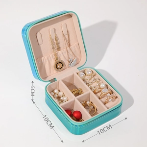 Macro view of portable iridescent cyan jewelry box showing 10x10x5cm dimensions and slots