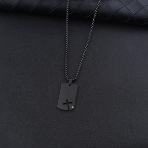 Detail of black military dog tag necklace with hollow cross and small rhinestone inlay