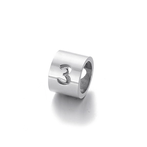 Macro detail of silver stainless steel ring featuring a hollow number 3 design element