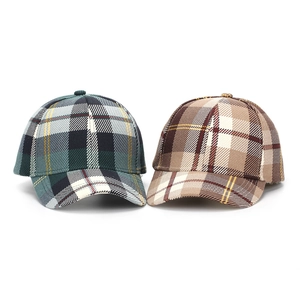 Close-up of the textured plaid fabric and structured crown on baseball caps