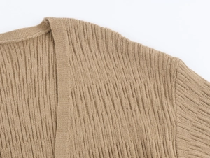 Detailed macro view showing the camel ribbed knit texture of the cardigan and vest set
