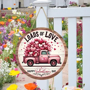 Wooden Valentine's Day welcome sign featuring a pink truck with hearts and Loads of Love