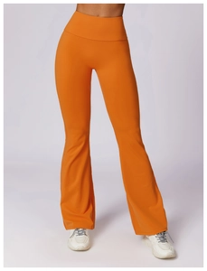 Macro shot of high-waist flared yoga pants in vibrant orange featuring wide tummy control