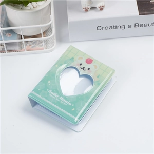 Detailed view of light green 3-inch photo album with cute bear and heart cutout cover