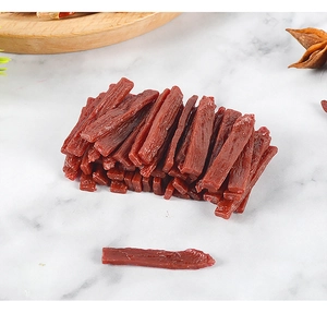 Macro detail of miniature PVC dried beef food model on marble background for dollhouses