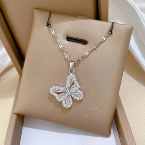 Detailed close-up of a silver butterfly pendant necklace with sparkling zircons
