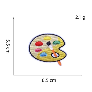 Macro view of paint palette embroidery patch with 5.5cm x 6.5cm size markings