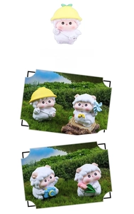 Detailed view of mini sheep resin figurines with cute hats and cameras for desk decor