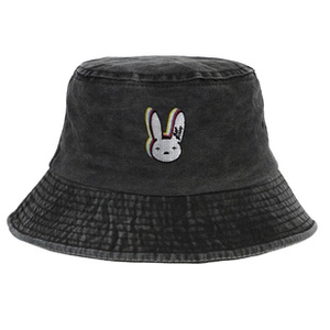 Detail of white rabbit embroidery and Bad Bunny logo on black washed denim bucket hat