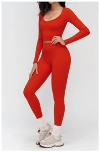Detailed view of red long sleeve yoga top and high waist leggings for athletic workouts