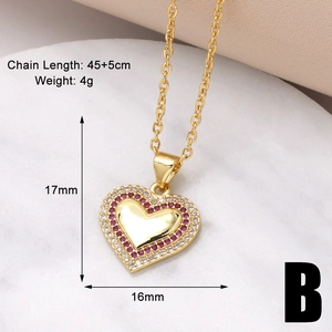 Macro view of gold heart pendant with red and white zircons, 45+5cm chain detail