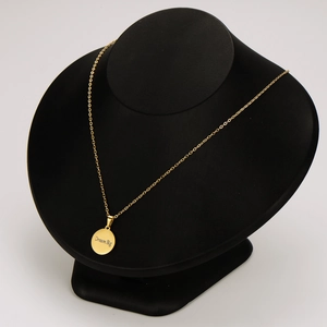 Elegant 18k gold plated necklace with Dream Big engraved round pendant on black mannequin