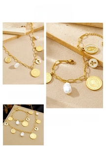 Detail of gold-plated necklace and bracelet set with baroque pearls and religious charms