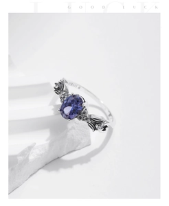 Detail of S925 sterling silver ring featuring an oval tanzanite-blue stone and retro texture