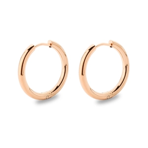 Macro shot of rose gold stainless steel hoop earrings with polished surface on white background