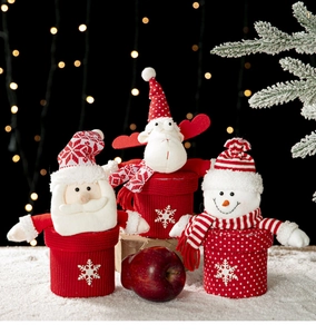 Detailed view of knitted Santa, reindeer, and snowman Christmas gift box decorations