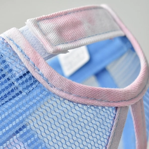 Detailed macro view of tie-dye cotton trim and breathable mesh fabric on sun visor hat