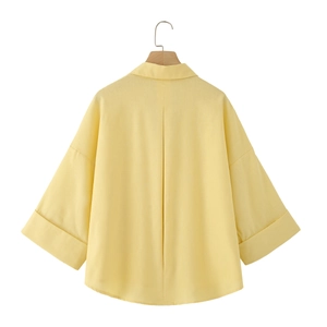 Minimalist light yellow linen V-neck shirt with wide sleeves and back pleat detail